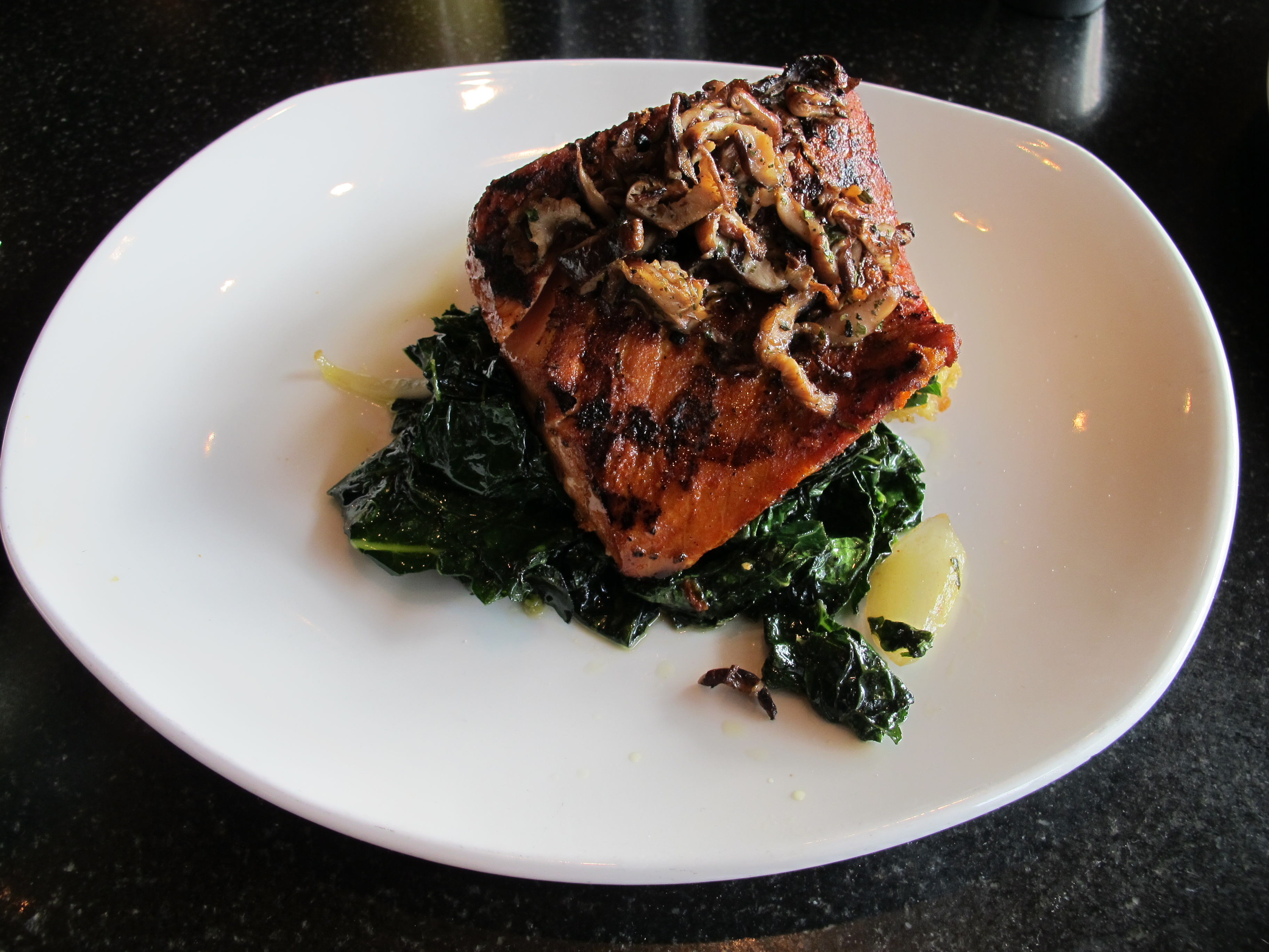 Etta's signature dish of salmon with sauteed buttered kale