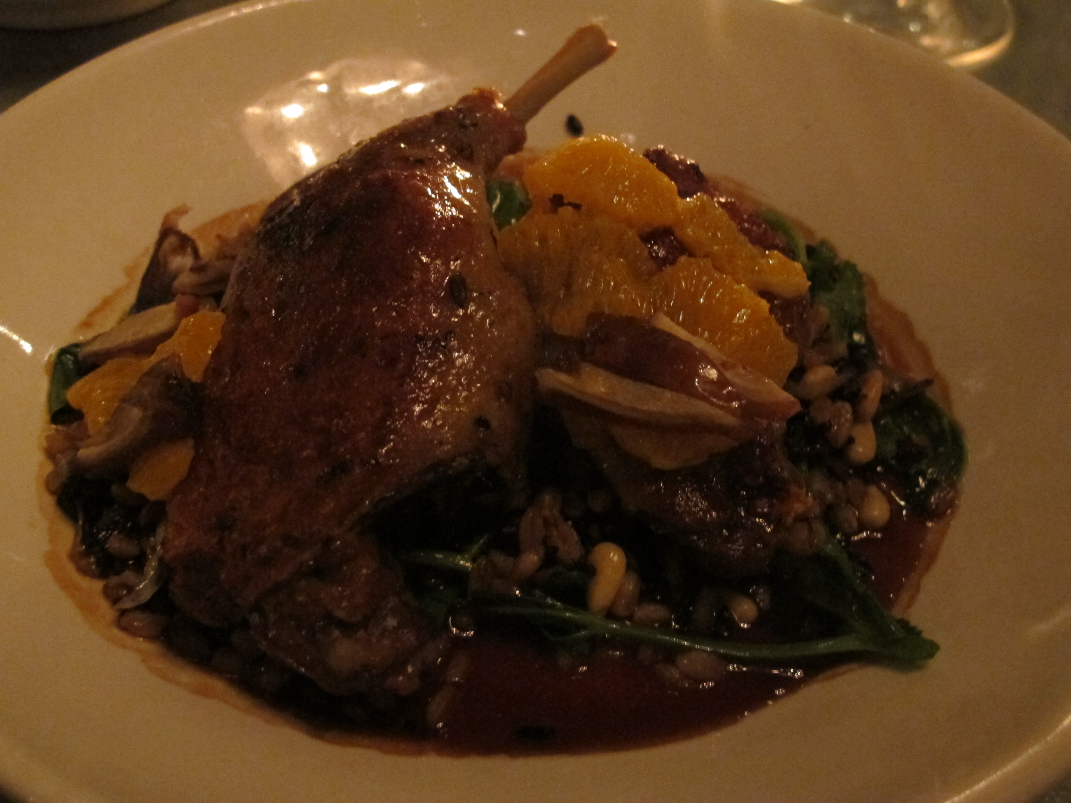 Duck confit with farro, black rice, pea shoots, tangerines and dates