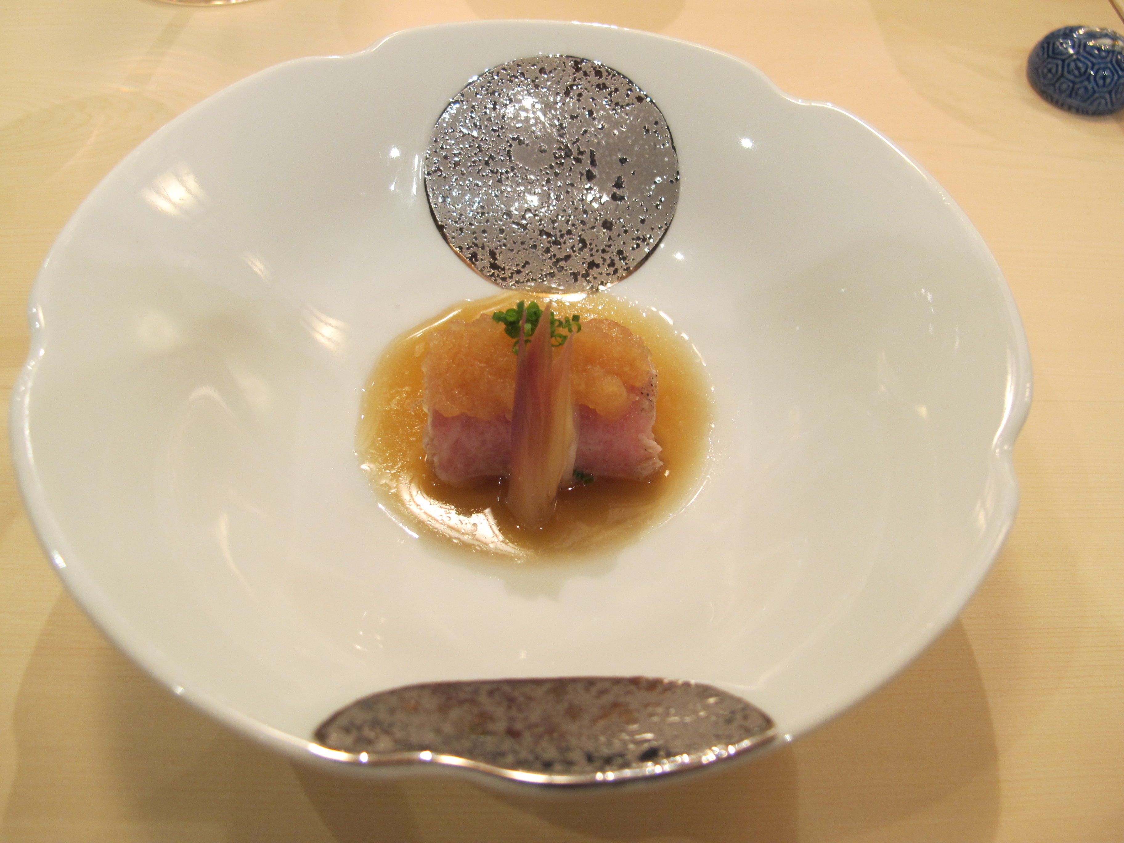 Toro wrapping a monkfish liver with a refreshing ponzu sauce