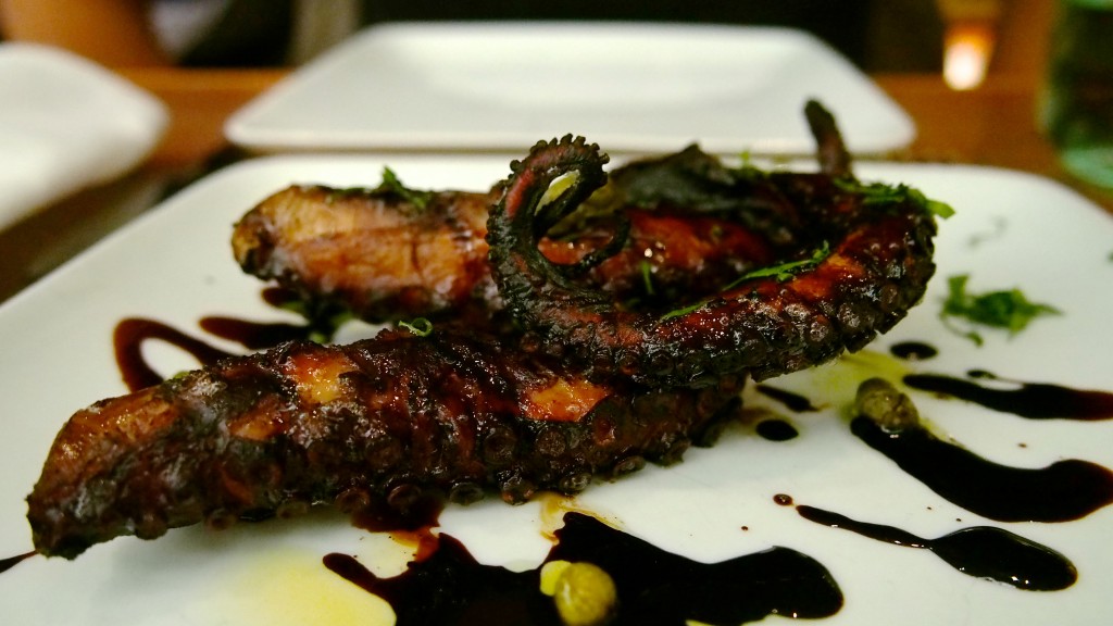 Grilled, marinated octopus with a balsamic reduction sauce and capers